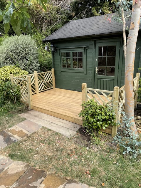 Garden decking with built-in seating by Crafted Spaces Ltd, Essex